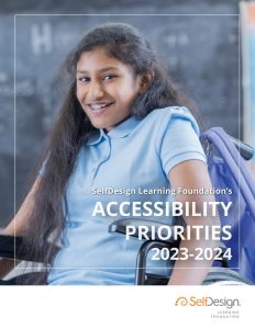 A teenage girl smiles in a wheelchair.