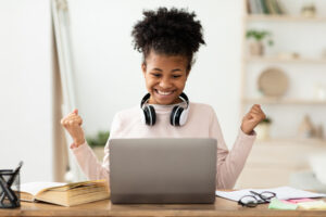 Excited Black Girl At Laptop Gesturing Yes.